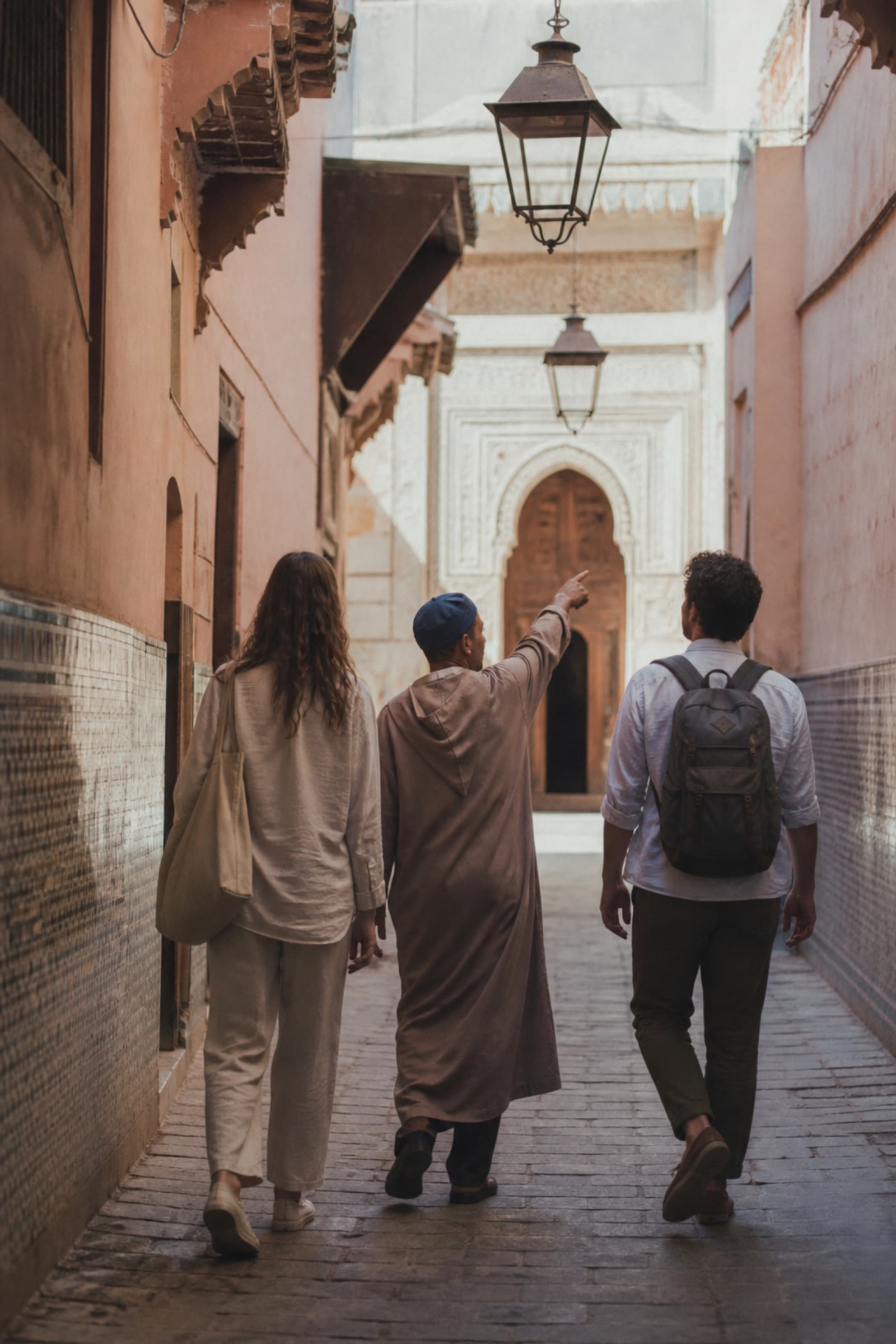 A host leading a small group of travelers through a medina
